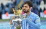 (Files) Manchester City's Portuguese midfielder Bernardo Silva lifts the Premier League trophy in Manchester, north west England, on May 23, 2021. (Photo by Peter Powell / Pool / AFP)