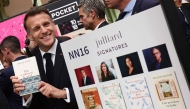 French President Emmanuel Macronvisits the Paris Book Fair at the Grand Palais in Paris on April 17, 2026. The fair, which runs until April 19, spotlights comic books as its central theme. (Photo by Teresa SUAREZ / POOL / AFP)