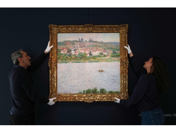 (FILES) Employees of the Sotheby's auction house handle the painting 