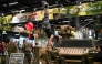 A visitor performs on a reconnaissance vehicle of the German Federal army Bundeswehr at their booth at the FIBO trade show for health, fitness and wellness in Cologne, western Germany on April 16, 2026. (Photo by Ina Fassbender / AFP)
