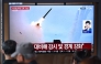 People watch a television screen showing a news broadcast with file footage of a North Korean missile test, at a train station in Seoul on April 19, 2026. Photo by Jung Yeon-je / AFP