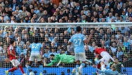 Manchester City's Norwegian striker #09 Erling Haaland (front R) shoots to score his team's second goal during the English Premier League football match between Manchester City and Arsenal at the Etihad Stadium in Manchester, north west England, on April 19, 2026. (Photo by Darren Staples / AFP)