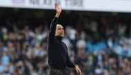 Manchester City's Spanish manager Pep Guardiola waves at the end of the English Premier League football match between Manchester City and Arsenal at the Etihad Stadium in Manchester, north west England, on April 19, 2026. (Photo by Darren Staples / AFP)