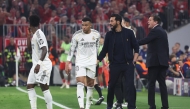 Real Madrid's Spanish coach Alvaro Arbeloa (2nd R) and Real Madrid's French forward #10 Kylian Mbappe (2nd L) are seen on the sidelines during the UEFA Champions League quarter-final second leg football match between FC Bayern Munich and Real Madrid in Munich, southern Germany, on April 15, 2026. (Photo by Karl-Josef HILDENBRAND / AFP)