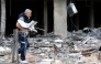 A man carries a machine he salvaged from the rubble of a destroyed building after returning to the southern Lebanese city of Nabatieh on April 20, 2026. (Photo by Mahmoud ZAYYAT / AFP)