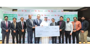 Regional Director of LuLu Hypermarket Qatar, Shanavas P M, presenting a cheque to Deputy Director of Donor Relations at Qatar Charity, Amer Mohammed AlBesiri.