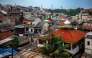 Houses are seen in a densely populated neighbourhood in Jakarta on April 21, 2026. (Photo by BAY ISMOYO / AFP)