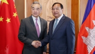 CAMBODIA-CHINA-DIPLOMACY
This handout photo taken and released by Agence Kampuchea Press (AKP) on April 23, 2026 shows Prak Sokhonn (R), Cambodian Deputy Prime Minister and Minister of Foreign Affairs and International Cooperation, shaking hands with China's Foreign Minister Wang Yi (L) during a meeting at the Ministry of Foreign Affairs in Phnom Penh. China's top diplomat Wang Yi is on a three-country tour of Southeast Asia this week, visiting Thailand and Myanmar after a first stop in Cambodia, Chinese officials said. (Photo by Handout / Agence Kampuchea Press (AKP) / AFP) 