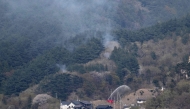 :JAPAN-WILDFIRE
A fire engine sprays water on a hill side near homes in the town of Otsuchi, in Iwate Prefecture on April 25, 2026.
(Photo by ANDREW CABALLERO-REYNOLDS / AFP)