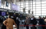 Passengers queue at the terminal hall after flights resumed at Imam Khomeini International Airport, amid a ceasefire between the US and Iran, in Tehran, Iran [Majid Asgaripour/WANA via Reuters]
