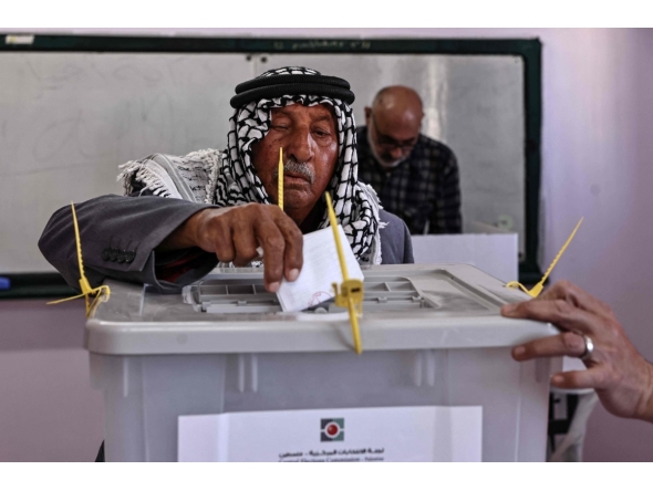 A Palestinian man casts his ballot at a polling station during municipal elections in Palestinian town of Birzeit, north of Ramallah in the Israeli-occupied West Bank on April 25, 2026. (Photo by Zain JAAFAR / AFP)

