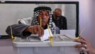 A Palestinian man casts his ballot at a polling station during municipal elections in Palestinian town of Birzeit, north of Ramallah in the Israeli-occupied West Bank on April 25, 2026. (Photo by Zain JAAFAR / AFP)
