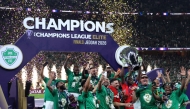 Al-Ahli players celebrate with the trophy after beating Machida Zelvia 1-0 in the final of the AFC Champions League football match between Al-Ahli Saudi FC and FC Machida Zelvia at the King Abdullah Sports City, in Jeddah on April 25, 2026. (Photo by Abdel Ghani BASHIR / AFP)