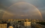 A general view shows the city skyline and a rainbow from the Tokyo Metropolitan Government Building observation deck in the Shinjuku district of central Tokyo on April 27, 2026. (Photo by Philip FONG / AFP)