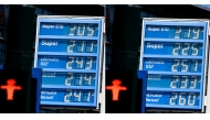 This combination of pictures created on April 25, 2026 shows a pricing board showing gas price at a gas station before noon (L) and gas price at a gas station after noon in Berlin on April 25, 2026. Photo by TOBIAS SCHWARZ / AFP