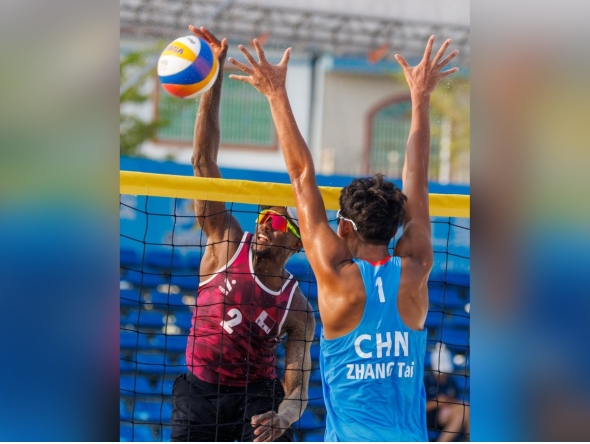 Qatar’s Ahmed Tijan (left) in action during the beach volleyball quarter-final against China. 