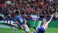 Arsenal's Brazilian defender #06 Gabriel Magalhaes challenges Atletico Madrid's French forward #07 Antoine Griezmann during the UEFA Champions League semi-final first leg football match between Club Atletico de Madrid and Arsenal at the Metropolitano stadium in Madrid on April 29, 2026. (Photo by Thomas COEX / AFP)
