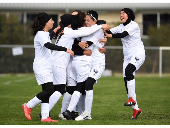 AFGHANISTAN-WOMEN-FIFA
Members of the Afghanistan's national women's football team playing under the Melbourne Victory Afghan women. (Photo by William WEST / AFP)  