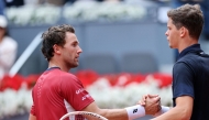Belgium's Alexander Blockx shakes hands with Norway's Casper Ruud after beating him during their 2026 ATP Tour Madrid Open tennis tournament quarter-final singles match at the Caja Magica in Madrid, on April 30, 2026. (Photo by Thomas COEX / AFP)
