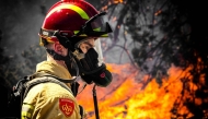 A firefighter works to extinguish a wildfire near Budel, on May 1, 2026 a day after it broke out at a military training ground where a military exercise was taking place. (Photo by ROB ENGELAAR / ANP / AFP)
