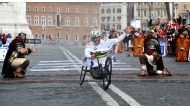 (Files) Former driver and paracyclist Alex Zanardi celebrates as he crosses the fininsh line of the 20th Marathon of Rome on March 23, 2014. (Photo by Tiziana Fabi / AFP)