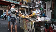 THAILAND-BANGKOK-FOOD-CULTURE-ECONOMY
Content :This photo taken on April 29, 2026 shows street food vendor Thitisakulthip Sang-uamsap selling fried vegetarian snacks to visitors in Chinatown in Bangkok. 
(Photo by Lillian SUWANRUMPHA / AFP) 
 