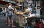THAILAND-BANGKOK-FOOD-CULTURE-ECONOMY
Content :This photo taken on April 29, 2026 shows street food vendor Thitisakulthip Sang-uamsap selling fried vegetarian snacks to visitors in Chinatown in Bangkok. 
(Photo by Lillian SUWANRUMPHA / AFP) 
 