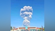 A handout picture taken and released by Indonesia's disaster mitigation agency (BNPB) on May 8, 2026, shows smoke rising from the eruption of Mount Dukono as seen from Tobelo, North Maluku. AFP PHOTO / Indonesia DISASTER MITIGATION AGENCY
