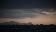 (Files) Image of merchant ships on the horizon in front of the port of El Callao in Lima on November 18, 2023. (Photo by Ernesto Benavides / AFP)
