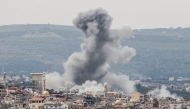  A photograph taken from the southern area of Tyre shows smoke rising from the site of an Israeli airstrike that targeted the area of Ras Al-Ain on May 12, 2026. (Photo by KAWNAT HAJU / AFP)