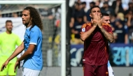 Roma's Italian midfielder #07 Lorenzo Pellegrini celebrates scoring his team's first goal next to Lazio's French midfielder #08 Matteo Guendouzi during the Italian Serie A football match between Lazio and Roma at the Olympic stadium in Rome, on September 21, 2025. (Photo by Tiziana FABI / AFP)