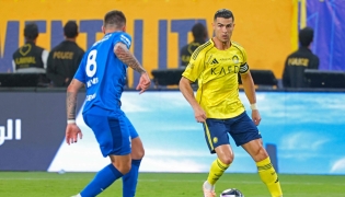Al Nassr's Portuguese forward #07 Cristiano Ronaldo fights for the ball with with Al Hilal's Portuguese midfielder #08 Ruben Neves during the Saudi Pro League football match between Al Nassr and Al Hilal at King Fahd Sports City Stadium in Riyadh on May 12, 2026. (Photo by Fayez NURELDINE / AFP)