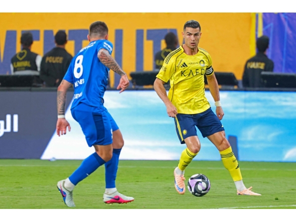 Al Nassr's Portuguese forward #07 Cristiano Ronaldo fights for the ball with with Al Hilal's Portuguese midfielder #08 Ruben Neves during the Saudi Pro League football match between Al Nassr and Al Hilal at King Fahd Sports City Stadium in Riyadh on May 12, 2026. (Photo by Fayez NURELDINE / AFP)
