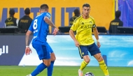 Al Nassr's Portuguese forward #07 Cristiano Ronaldo fights for the ball with with Al Hilal's Portuguese midfielder #08 Ruben Neves during the Saudi Pro League football match between Al Nassr and Al Hilal at King Fahd Sports City Stadium in Riyadh on May 12, 2026. (Photo by Fayez NURELDINE / AFP)
