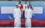 Secretary General of the Qatar Olympic Committee and Vice Chairman of the Organising Committee of the Games Jassim bin Rashid Al Buenain with the podium winners of the men’s 200m individual medley, won by Qatar's Mohamed Mahmoud.