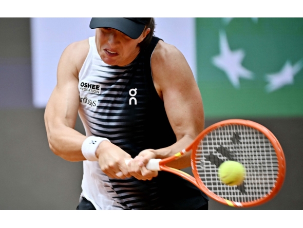 Poland's Iga Swiatek hits a return to USA's Jessica Pegula during the ATP Rome Open tennis tournament at Foro Italico in Rome on May 13, 2026. (Photo by Filippo MONTEFORTE / AFP)
