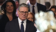 Britain's Prime Minister Keir Starmer (C) returns to the House of Commons after listening to the king's speech during the State Opening of Parliament at the Palace of Westminster in London on May 13, 2026. (Photo by Toby Melville / Pool / AFP)
