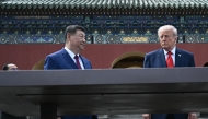 China's President Xi Jinping (C) and US President Donald Trump (R) visit the Temple of Heaven in Beijing on May 14, 2026. (Photo by Brendan Smialowski / Pool / AFP)