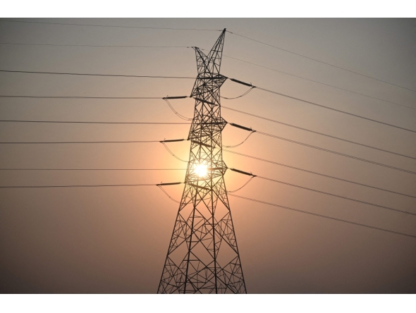(Files) This file photo taken on April 16, 2026 shows the sun setting next to power lines along San Fernando town, Pampanga province, north of Manila. (Photo by Ted Aljibe / AFP)