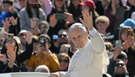 Pope Leo XIV waves to the crowd during the weekly general audience at St Peter's Square in The Vatican on April 8, 2026. Photo by Tiziana FABI / AFP