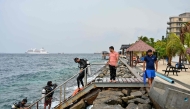 A tourist, along with guides, returns after an open-water diving session near Rasfannu Beach in Malé on May 15, 2026. Photo by Mohamed Afrah / AFP