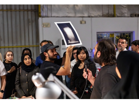 Habeeb Abu-Futtaim (holding the image) and Yousef Bahzad (with the mic) are previewing the artwork. Pic: Maria Ovsyannikova