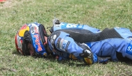 Team Gresini Racing MotoGP's Alex Marquez lies on the side of the track after crashing at high speed during the 2026 Catalunya Moto GP Grand Prix at the Catalunya racetrack in Montmelo, near Barcelona, on May 17, 2026. (Photo by JOSE JORDAN / AFP)