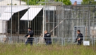 A picture showing heavily armed police officers in an industrial area at a cage facility in Schkeuditz near Leipzig, Saxony, eastern Germany, after an escaped tiger injured a man and was shot dead.  (Photo by Bjِrn Stach / dpa / AFP) / Germany OUT
 