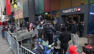 This photo taken on May 15, 2026, shows people camping out in line outside of the Swatch store in Times Square in New York, ahead of the May 16 release of the Audemars Piguet x Swatch Royal Pop watch. Photo by Timothy A. Clary / AFP

