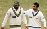 Pakistan's Inzamam-ul-Haq (left) and India's Rahul Dravid leave the ground at close of play on the last day of the first Test match in Lahore, in this January 17, 2006 file photo. AFP