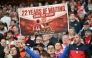 (FILES) A hopeful Arsenal fan holds up a banner reading '22 years of waiting' ends this season, during the English Premier League football match between Arsenal and Burnley at the Emirates Stadium in London on May 18, 2026. (Photo by Glyn KIRK / AFP)