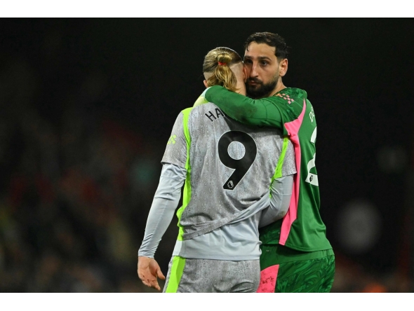 Manchester City's Italian goalkeeper #25 Gianluigi Donnarumma hugs Manchester City's Norwegian striker #09 Erling Haaland after the English Premier League football match between Bournemouth and Manchester City at the Vitality Stadium in Bournemouth, southern England on May 19, 2026. (Photo by Glyn KIRK / AFP)

