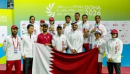 Qatar's medal-winning archers and officials pose for a photo.