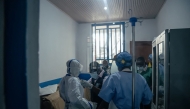Dr Abdou Sebushishe (2nd L) Senior Health Advisor at International Medical Corps, guides and shows CBCA Virunga doctors how to properly put on single-use personal protective equipment provided by International Medical Corps, as part of support for Ebola virus disease prevention measures in Goma, on May 21, 2026. (Photo by Jospin Mwisha / AFP)